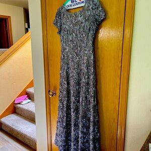 Elegant evening gown. Full length. Natural tone with ribbon details.